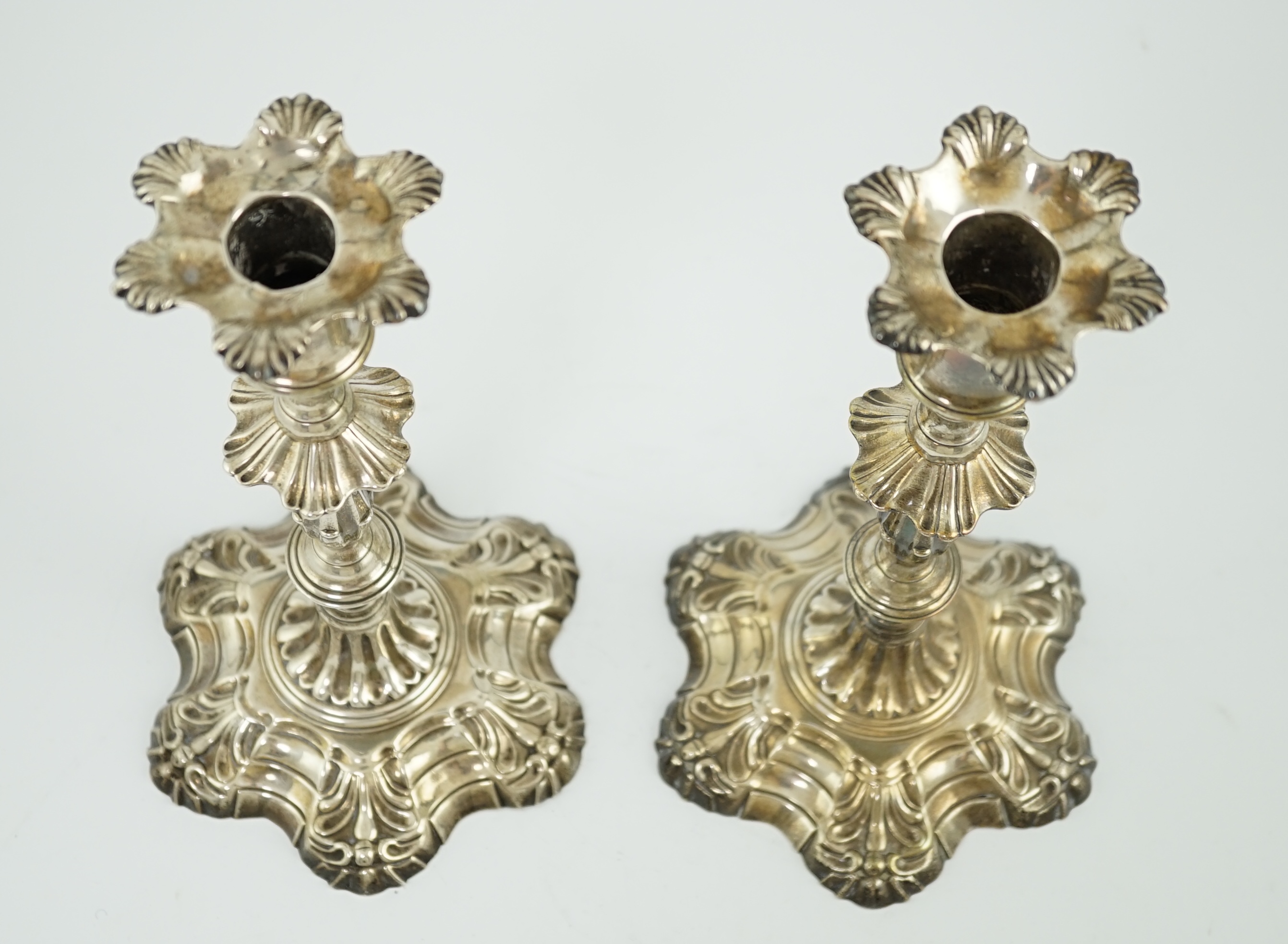 A pair of early George III cast silver candlesticks, by William Cafe